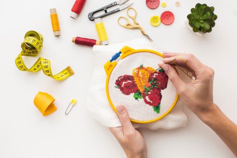 hands-sewing-cute-fruit-design-white-background